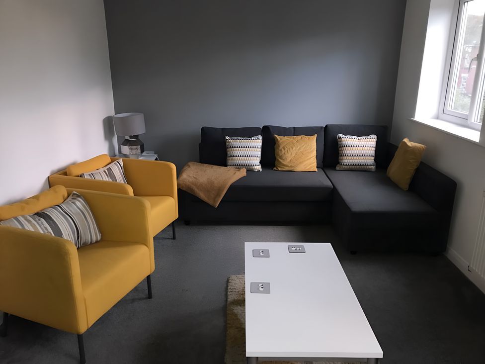 A living room with a sofa and armchairs at an unspecified location