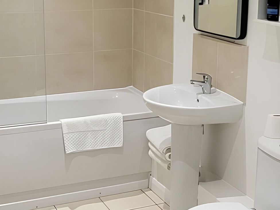 A bathroom with a bathtub and washbasin at 