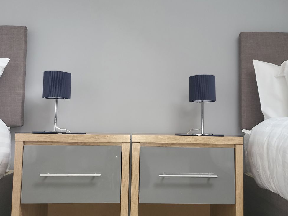 A bedroom with bedside tables and lamps at 