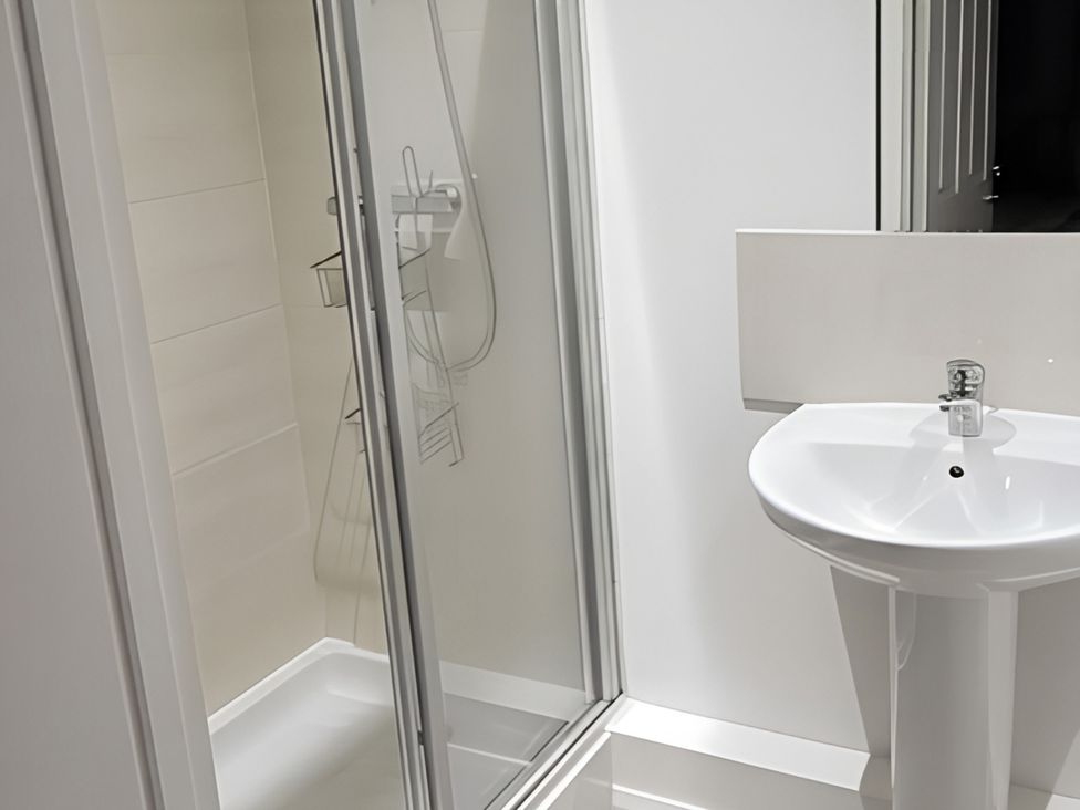 A bathroom with a shower and a sink at The Old Barn in Manchester