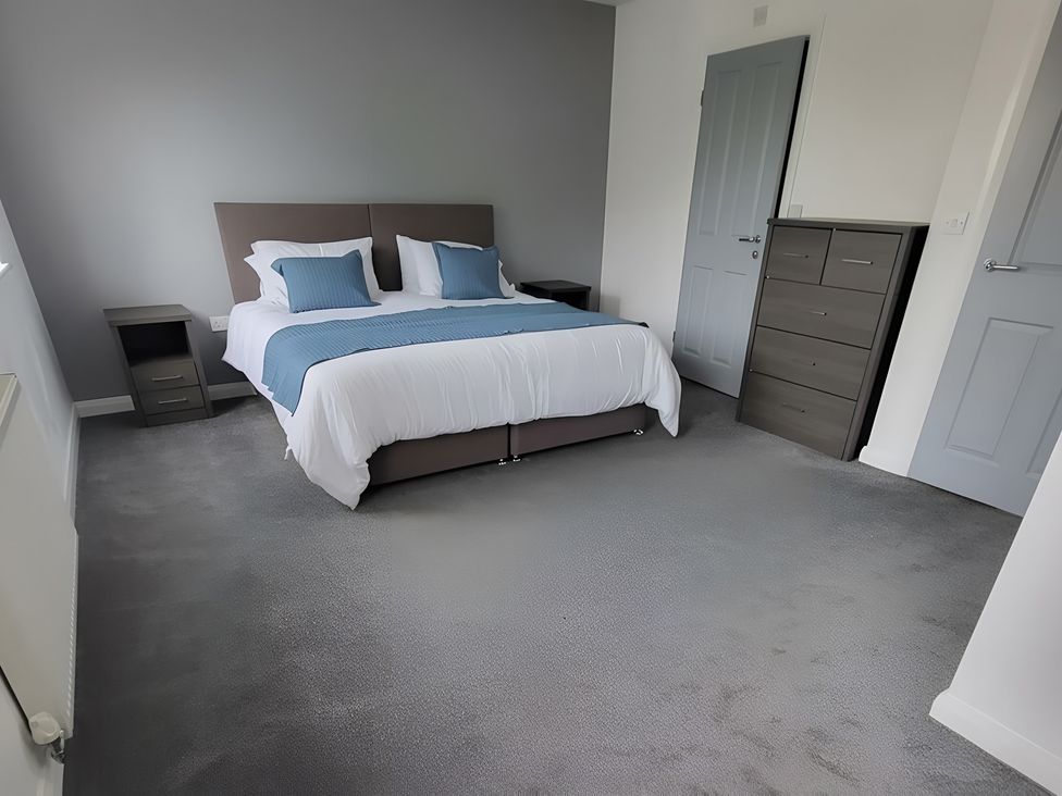 A bedroom with a bed and furniture at The Old Barn in Manchester