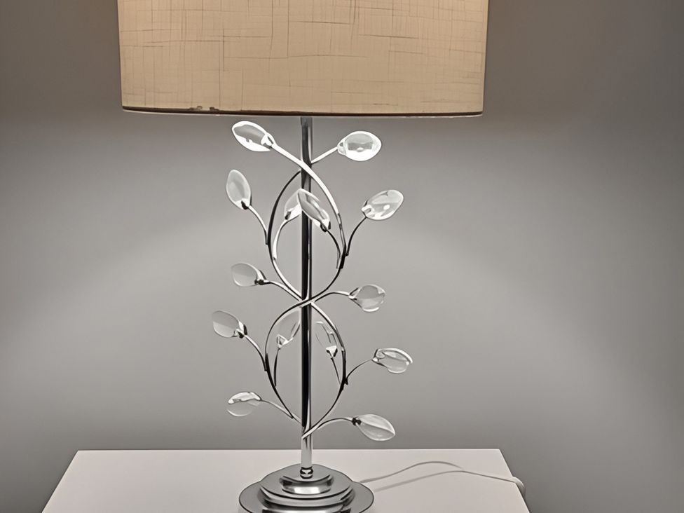 A lamp with a decorative base on a table