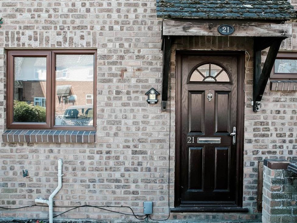 A front door and window on a brick wall at 21