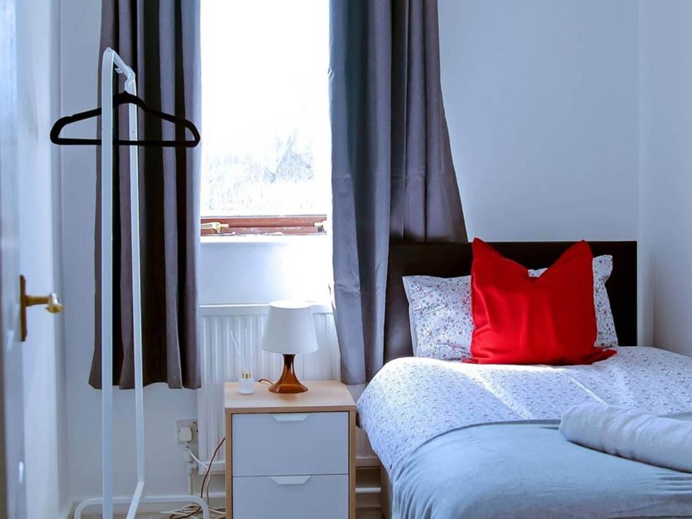 A bedroom with a bed and bedside table at the property in location