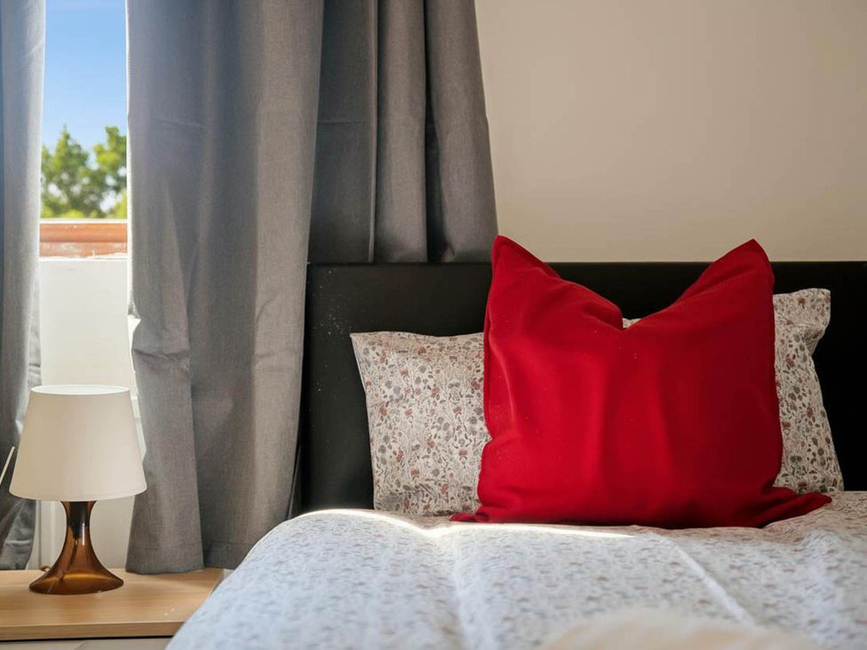 A bedroom with a bed and lamp at 