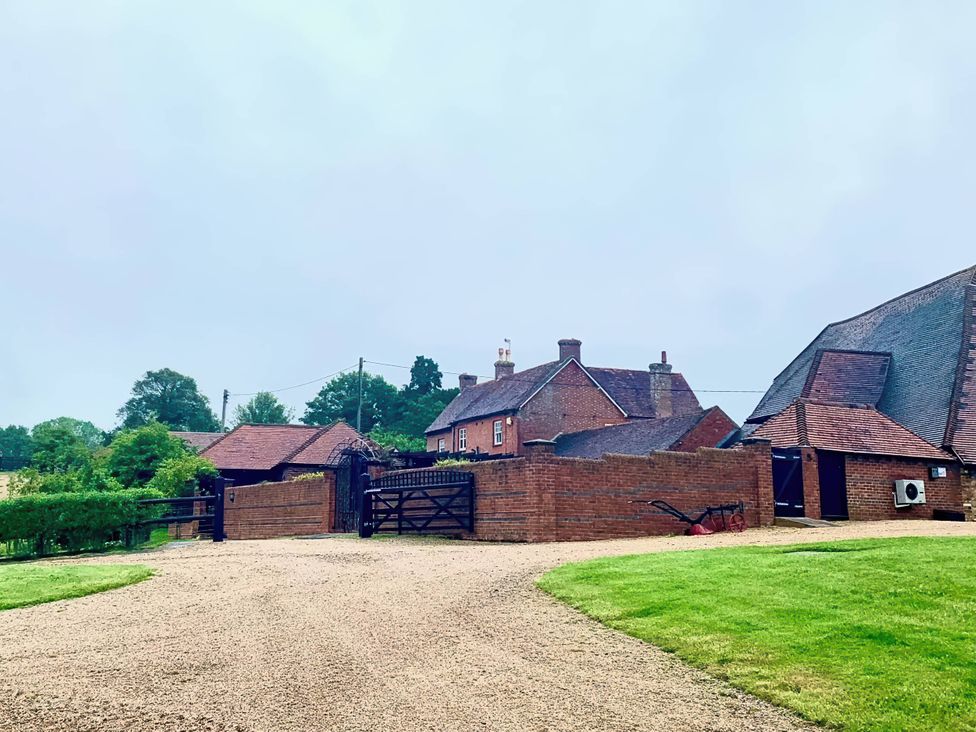 A house with a gate and gravel driveway at a property