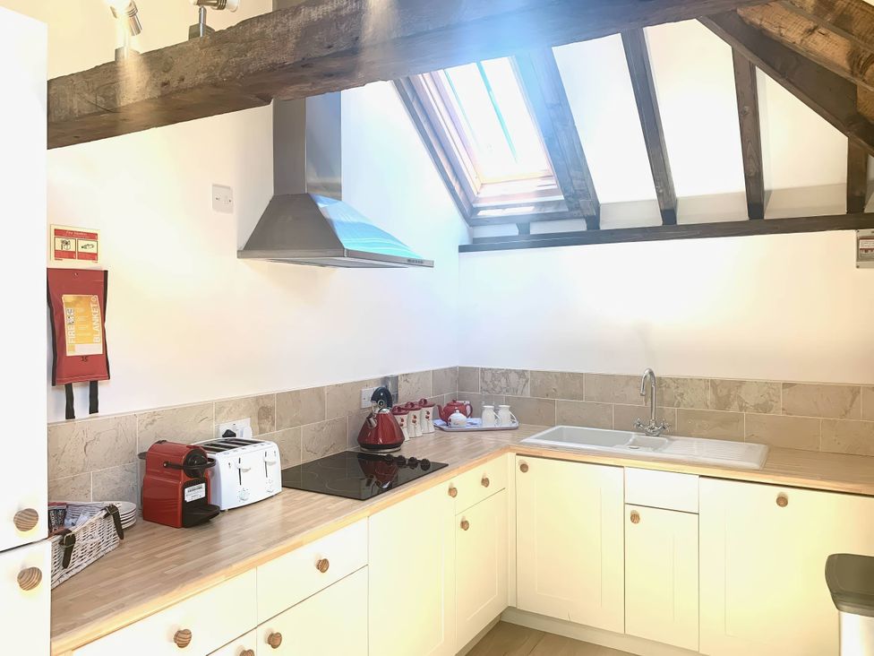 A kitchen with a sink and appliances at The Old Barn in Manchester