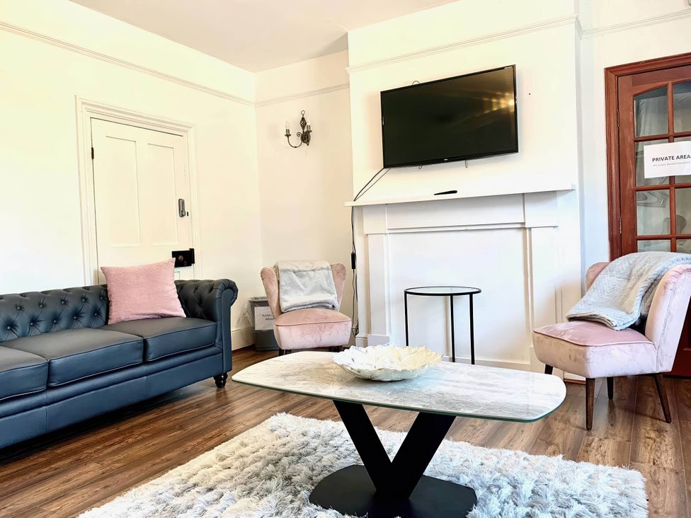 A living room with a sofa, table, and television