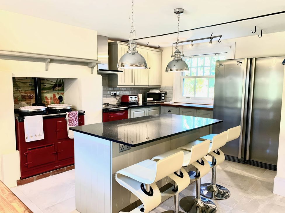 A kitchen with a kitchen island and bar stools at '' in ''