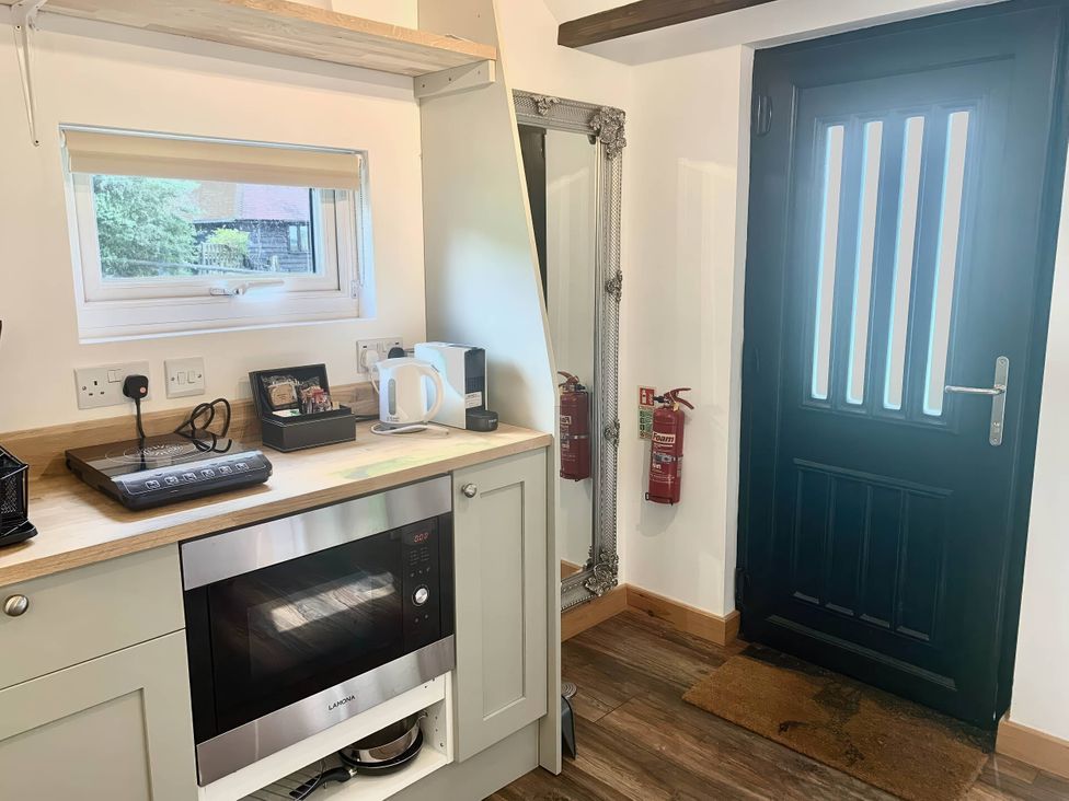 A kitchen with a microwave and kettle at The Old Barn in Manchester