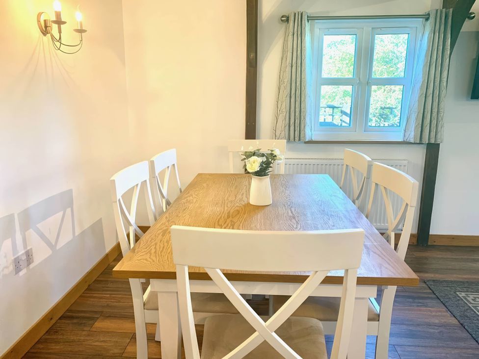 A dining room with a table and chairs at The Old Barn in Manchester