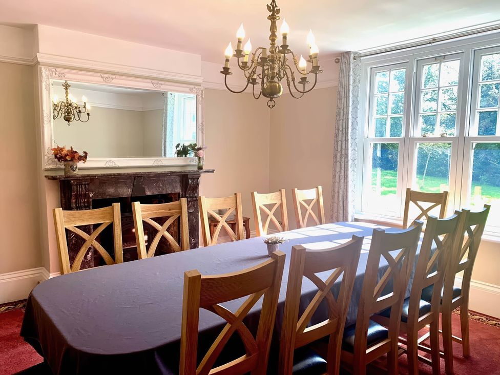 A dining room with a large table and chairs at The Old Barn in Manchester