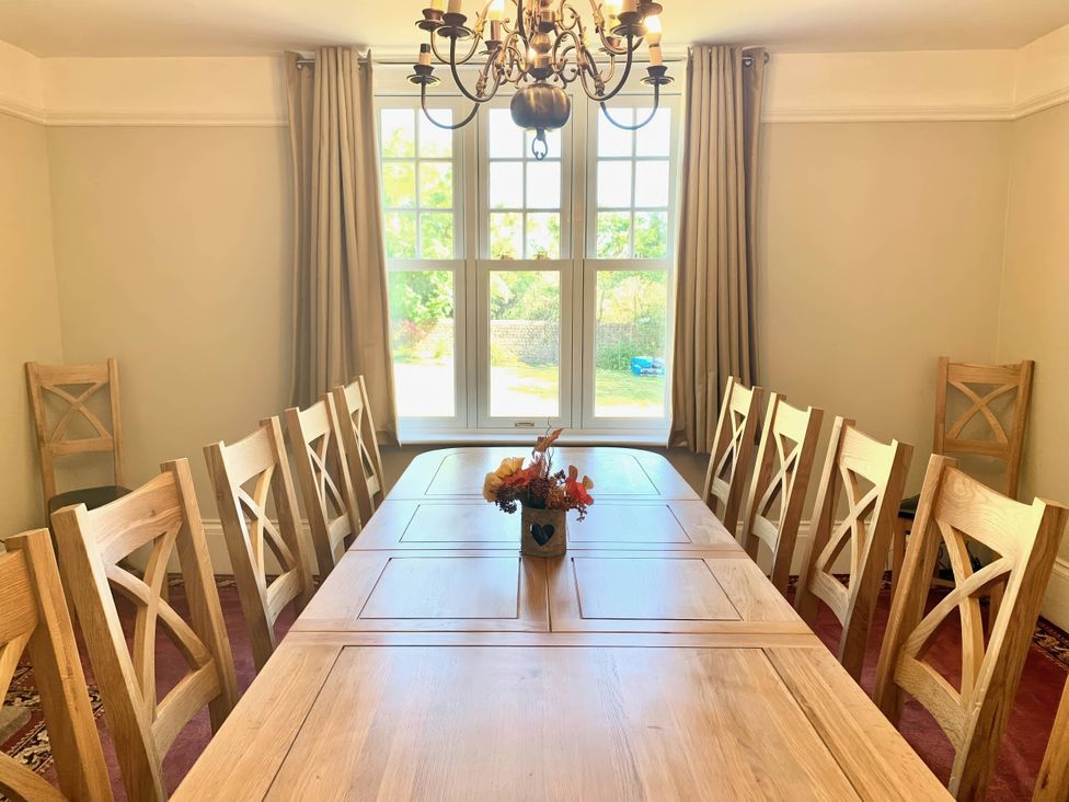 A dining room with a wooden table and chairs at a property