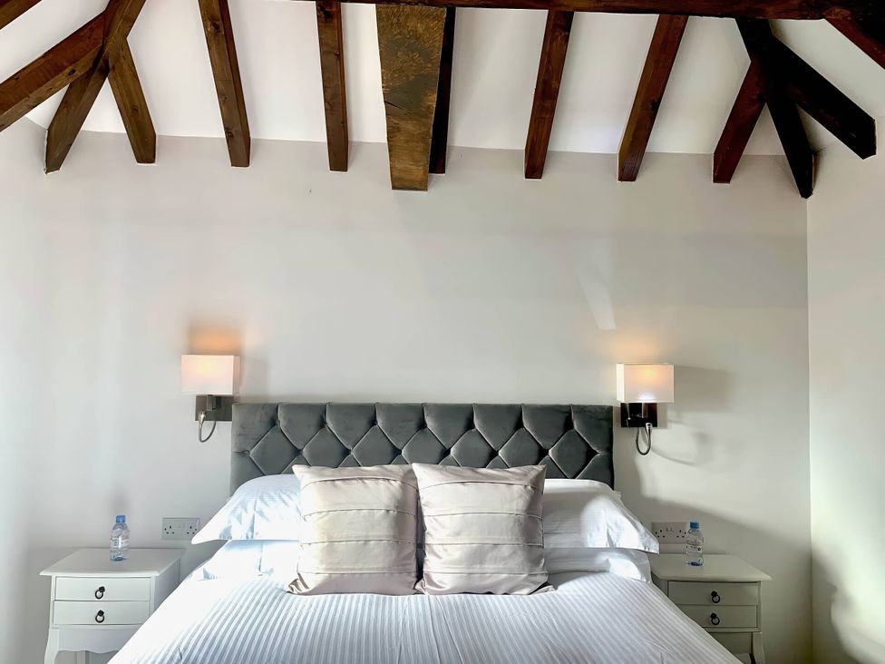 A bedroom with a bed and bedside table at The Old Barn in Manchester