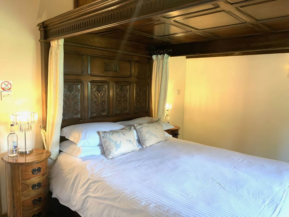 A bedroom with a bed and bedside table at The Old Barn in Manchester