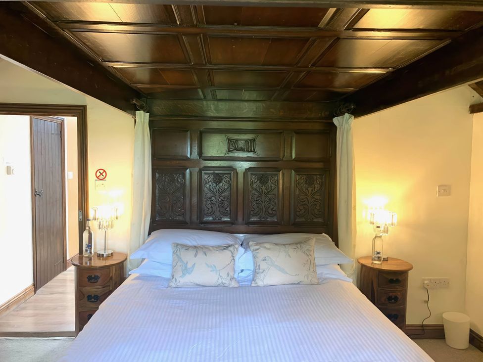 A bedroom with a bed and bedside tables at The Old Barn in Manchester