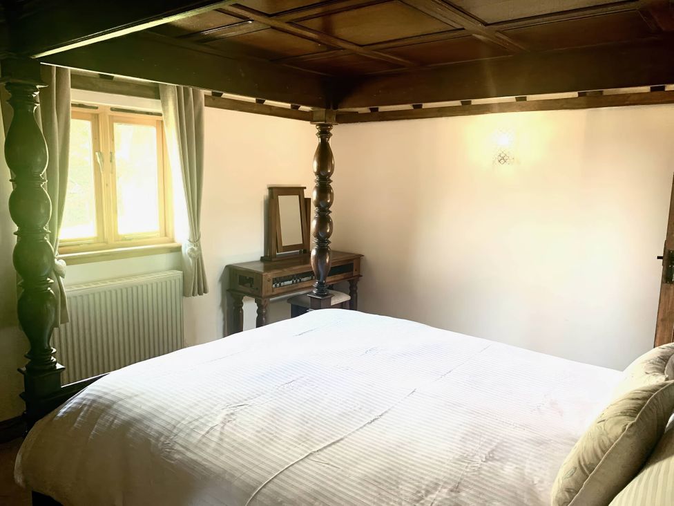 A bedroom with a bed and a window at The Old Barn in Manchester