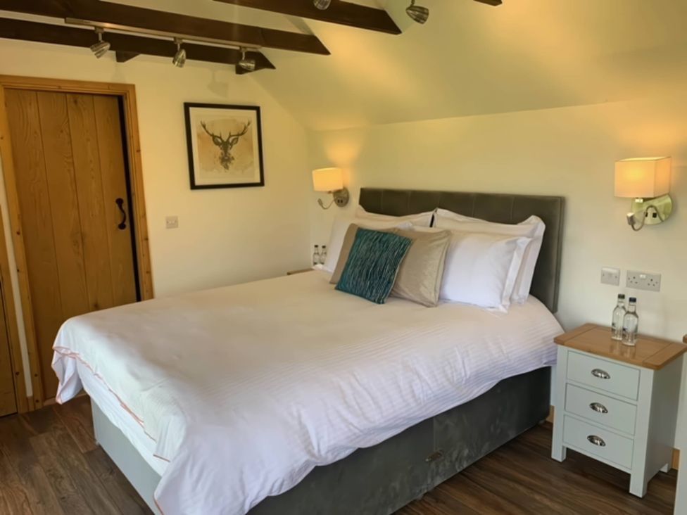 A bedroom with a bed and side table at The Old Barn in Manchester