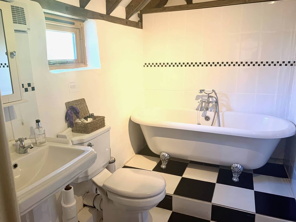A bathroom with a bathtub and sink at The Old Barn in Manchester