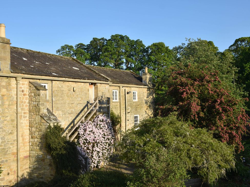 A building with a staircase and flowering plants at 