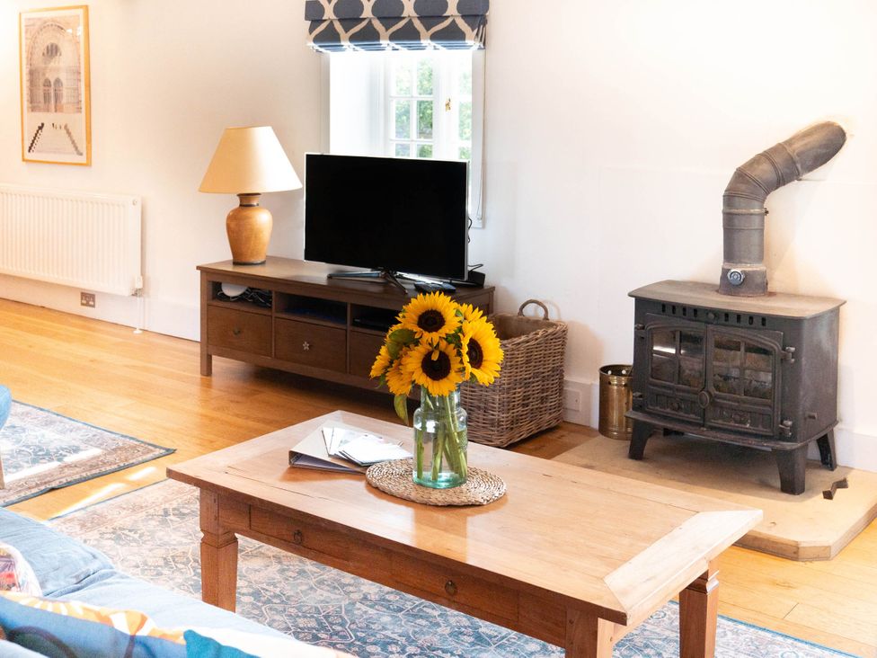 A living room with a coffee table and a television at the property