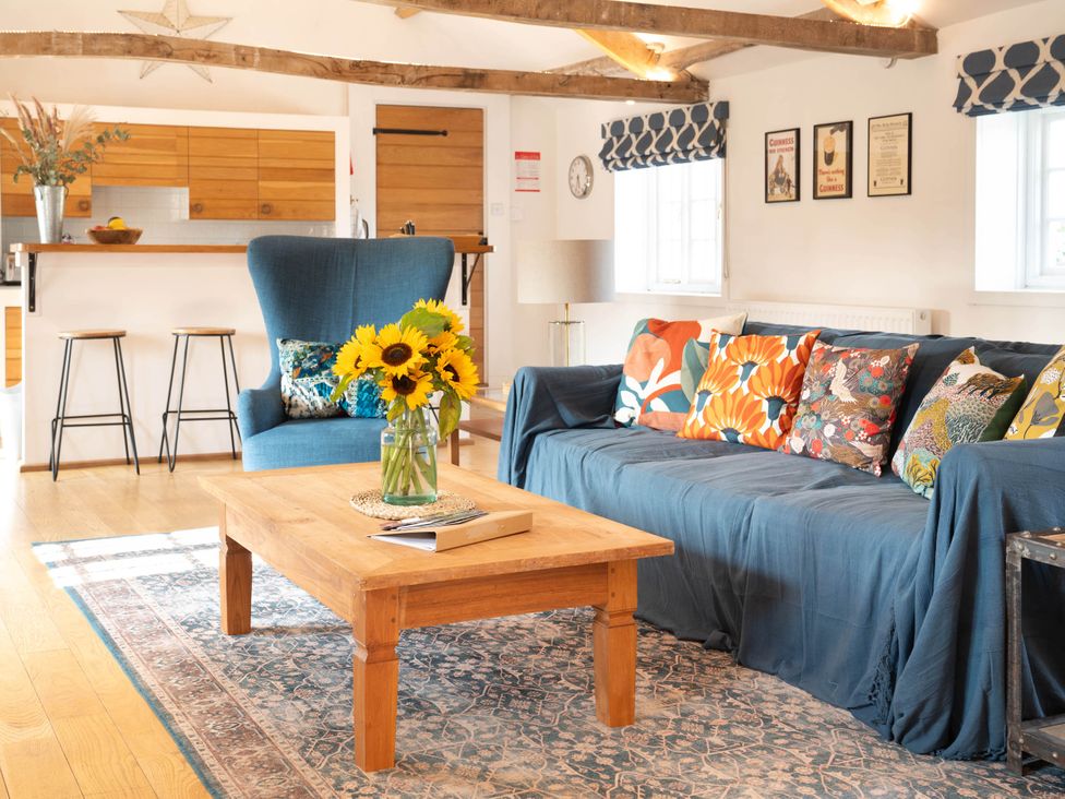 A living room with a sofa and armchair at The Old Barn in Manchester