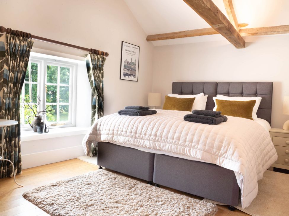 A bedroom with a bed and bedside tables at The Old Barn in Manchester