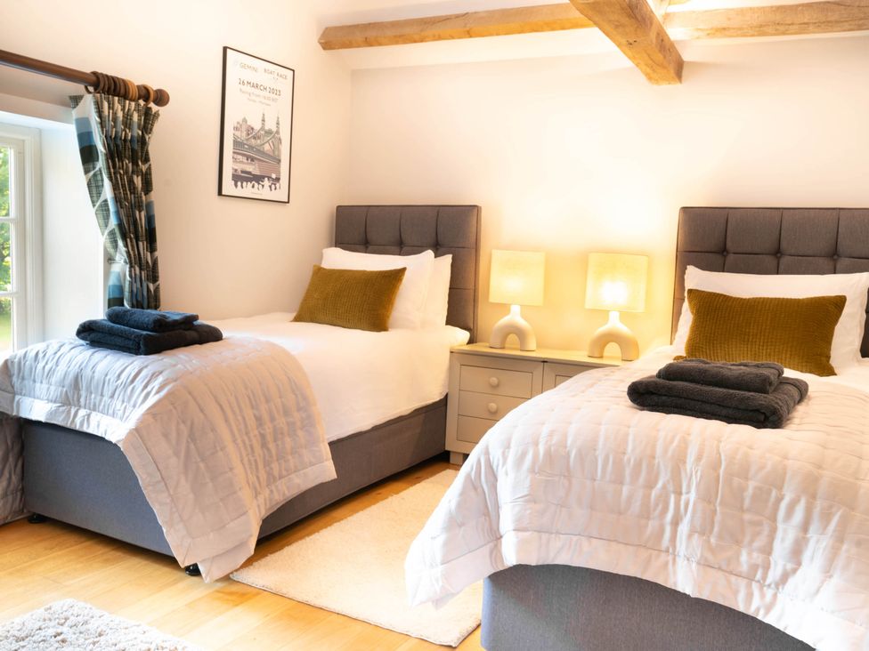 A bedroom with two beds and a window at The Old Barn in Manchester