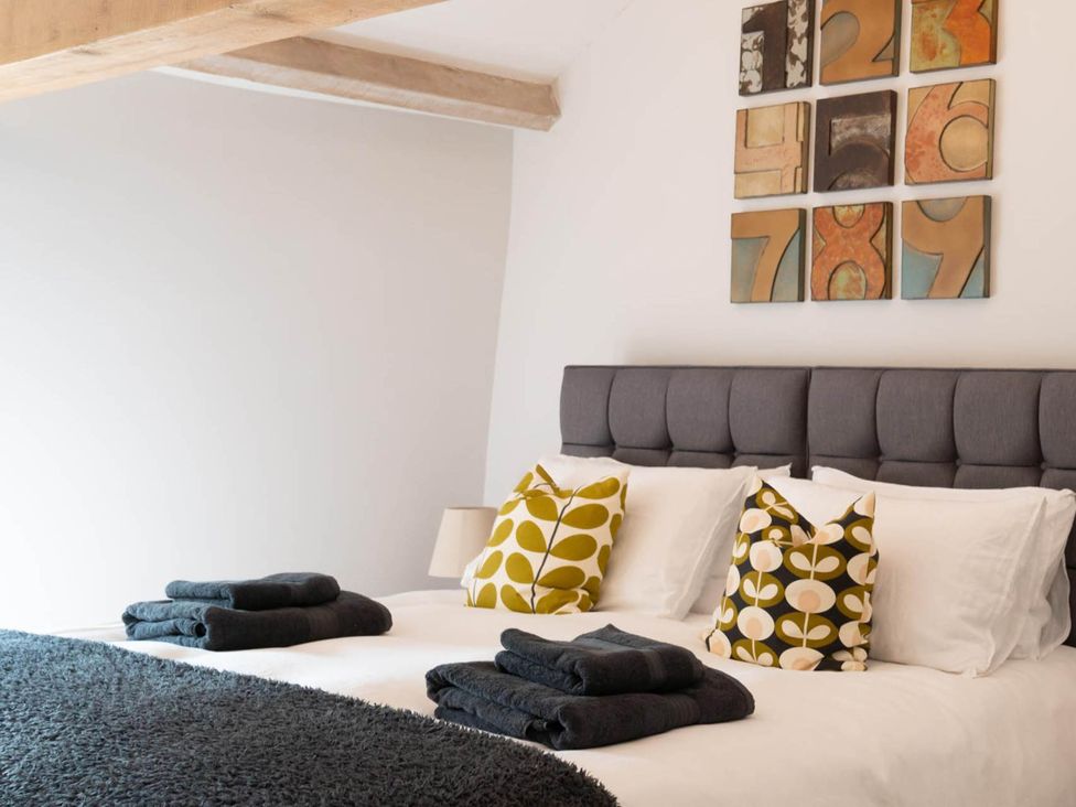 A bedroom with a bed and decorative pillows at the scenic property in an undisclosed location