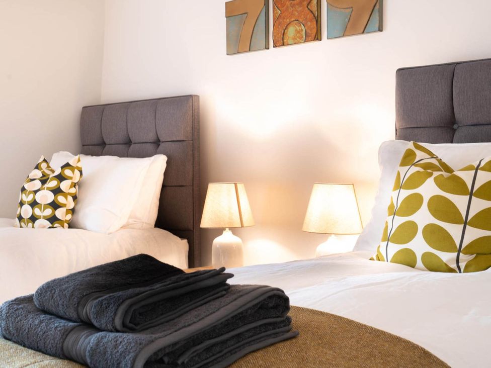 A bedroom with two beds and lamps at 