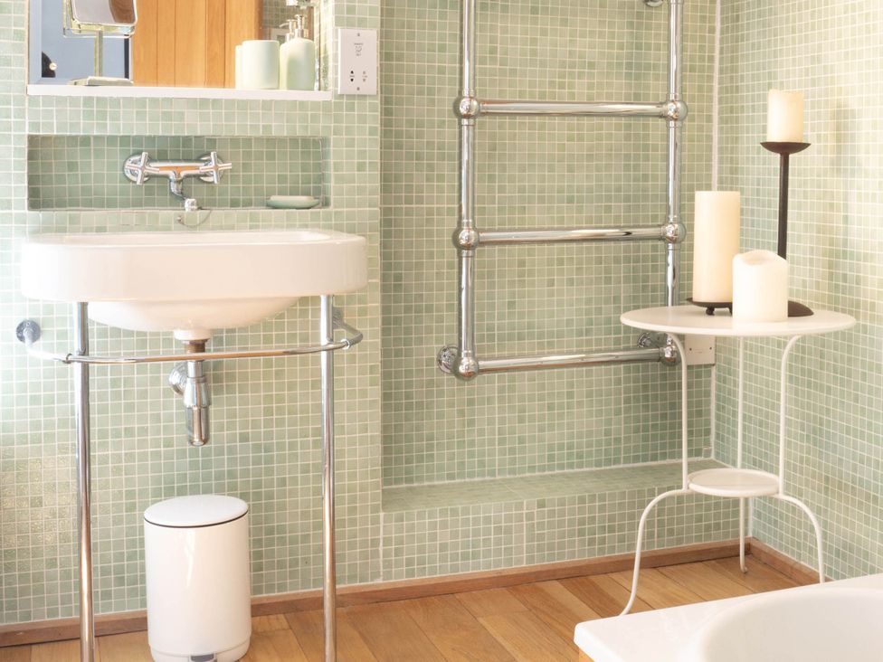 A bathroom with a sink and towel radiator at The Old Barn in Manchester