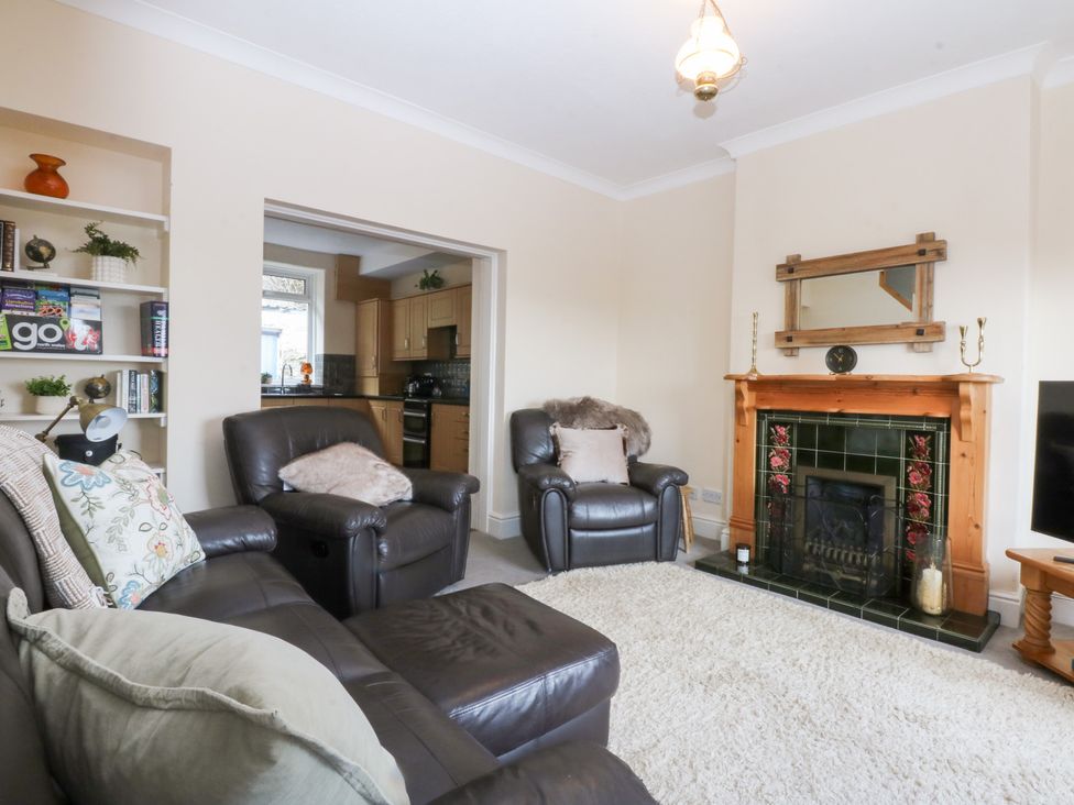 A living room with furniture and a fireplace at 3 Bay View Terrace in Llandegfan
