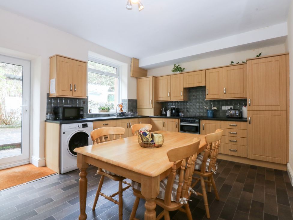 A kitchen with cabinets and appliances at 3 Bay View Terrace in Llandegfan