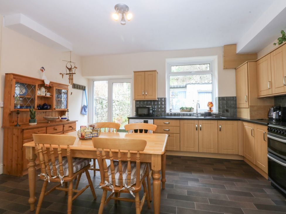 A kitchen with a dining table and chairs at 3 Bay View Terrace in Llandegfan