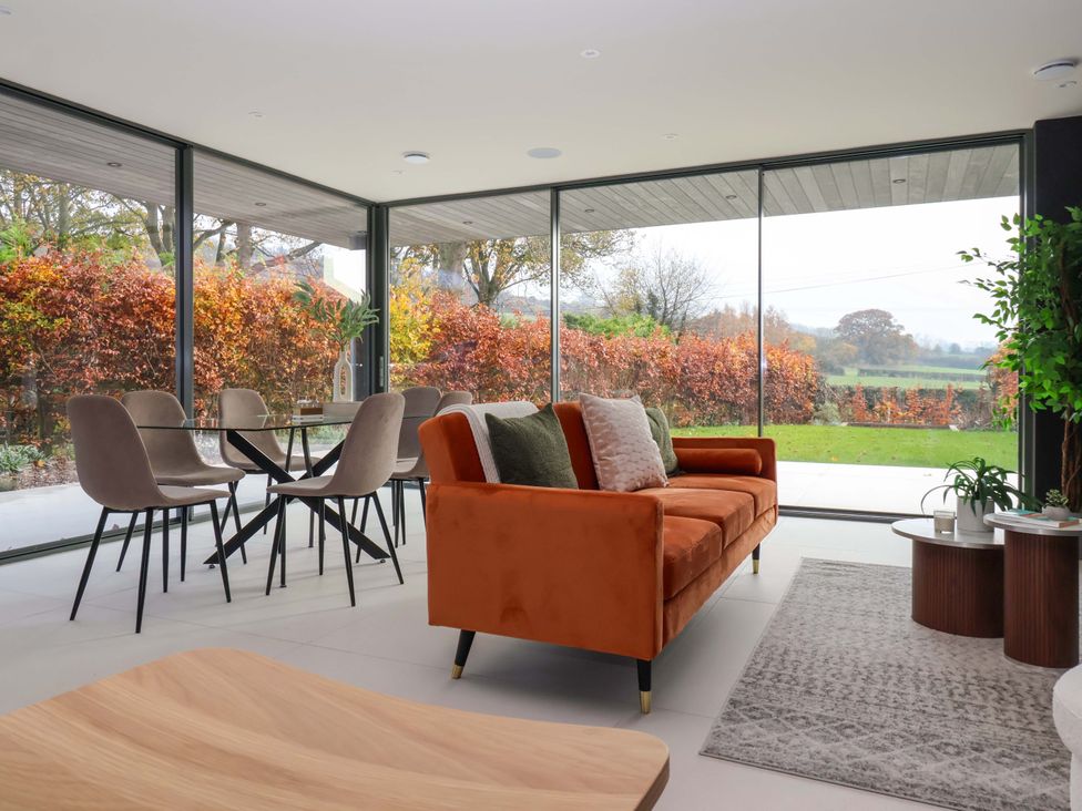A living room with a sofa and dining table at Woldside in York