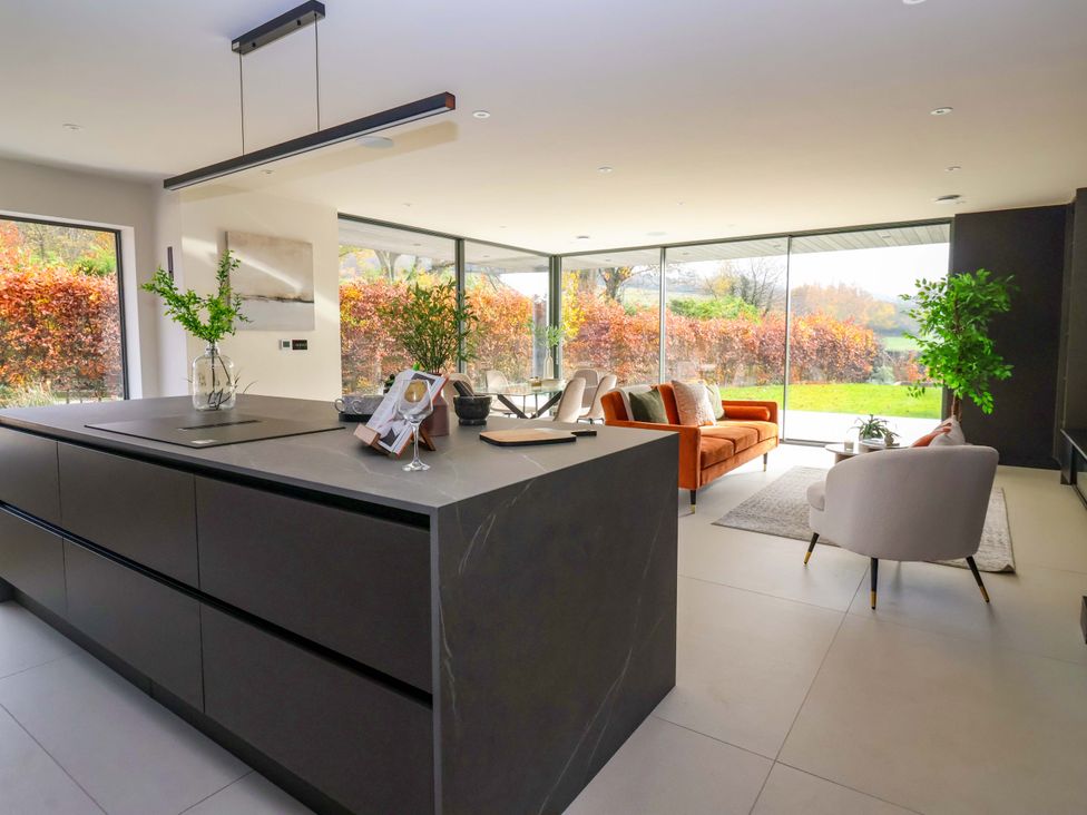 A kitchen with a kitchen island and seating area at Woldside in York