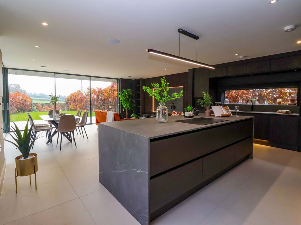 A kitchen with a dining area and large windows at Woldside in York