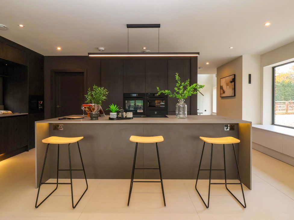 A kitchen with an island and stools at Woldside in York