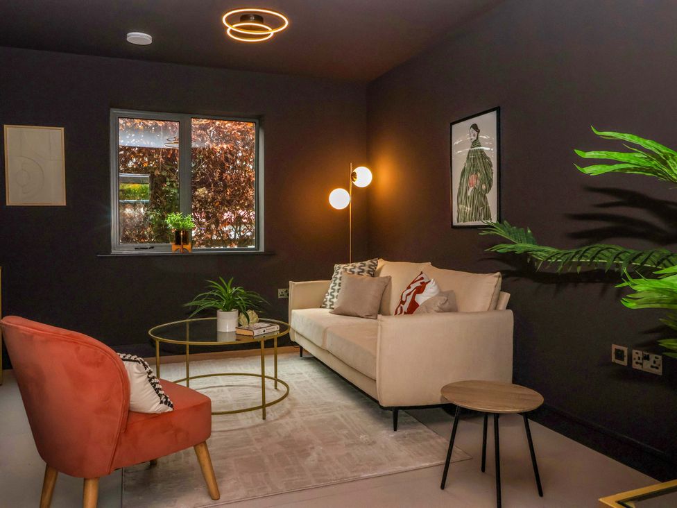 A living room with a sofa and armchair at Woldside in York