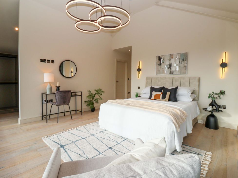 A bedroom with a bed and desk at Woldside in York