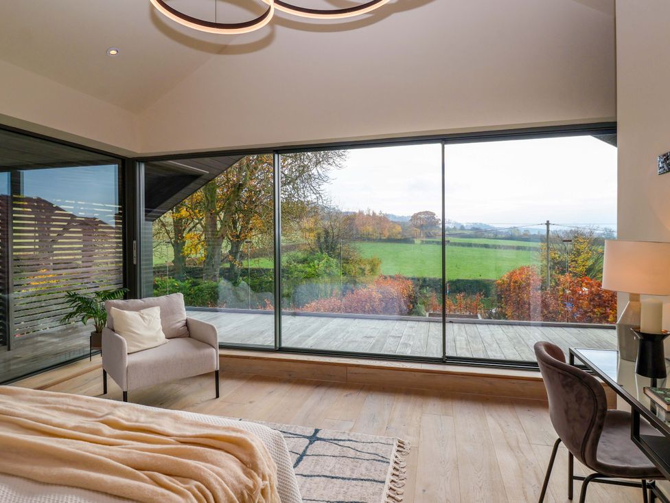 A bedroom with large windows and a view at Woldside in York