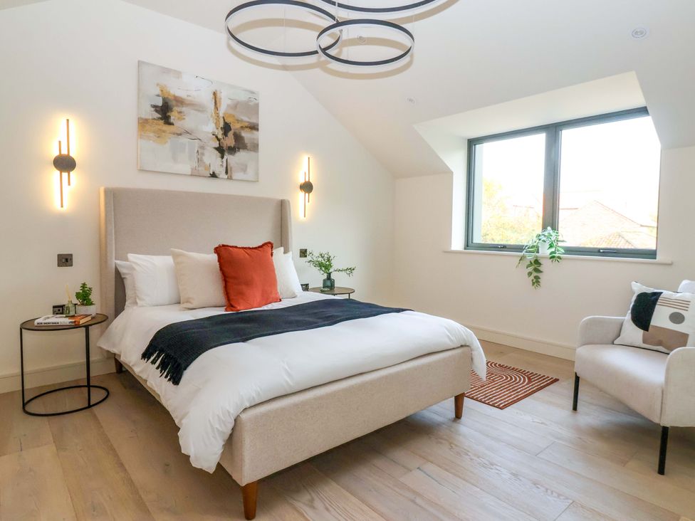 A bedroom with a bed and a chair at Woldside, York