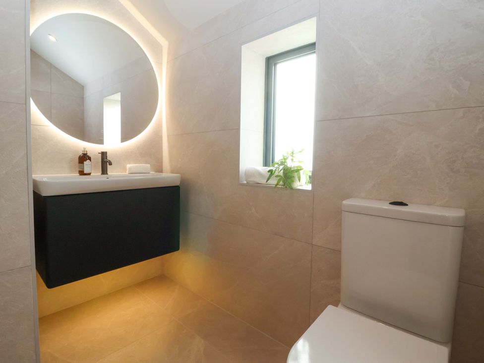 A bathroom with a sink, toilet and window at Woldside in York