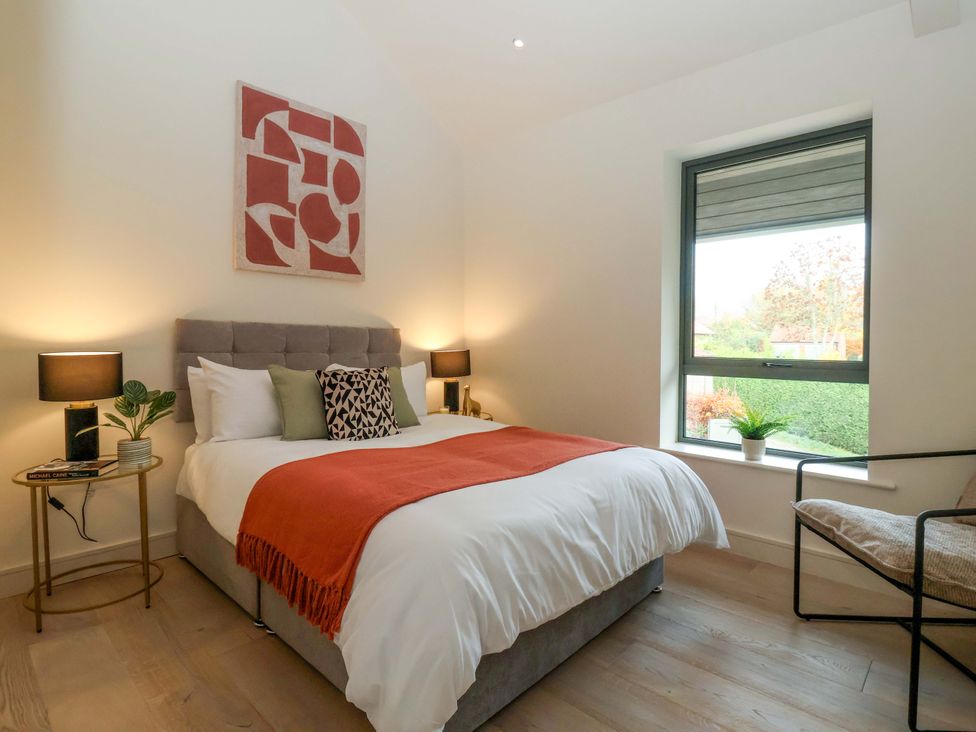 A bedroom with a bed and two lamps at Woldside in York