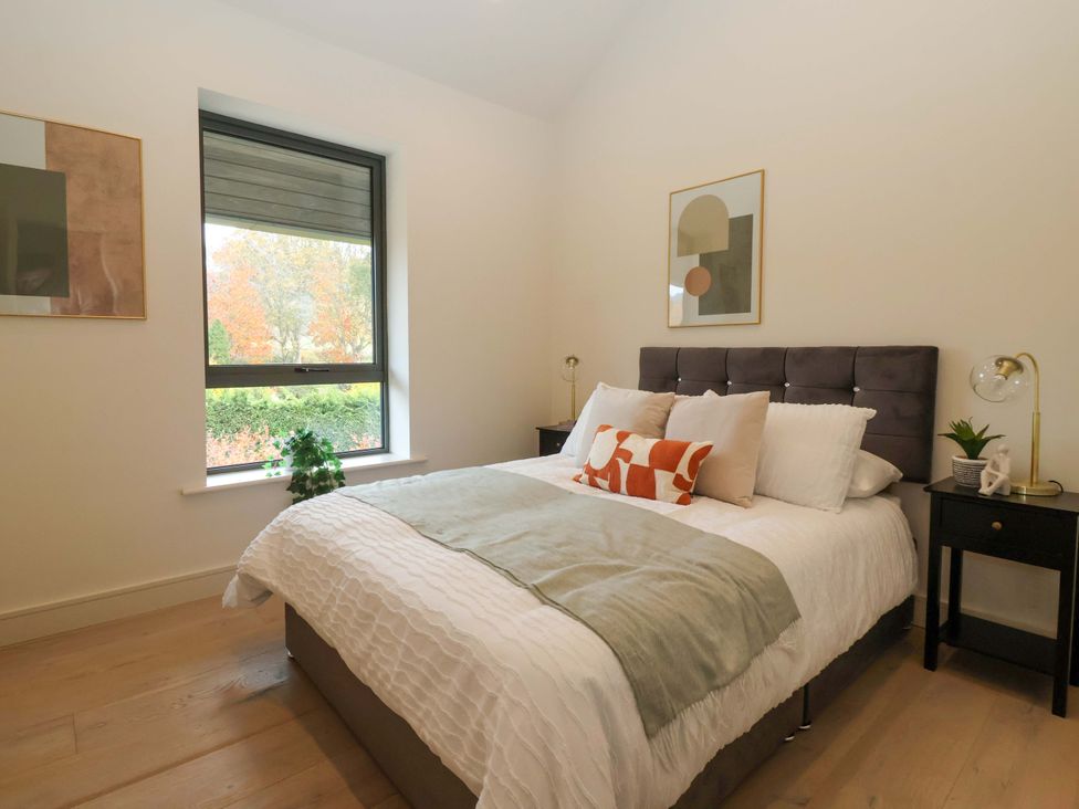 A bedroom with a bed and nightstand at Woldside in York