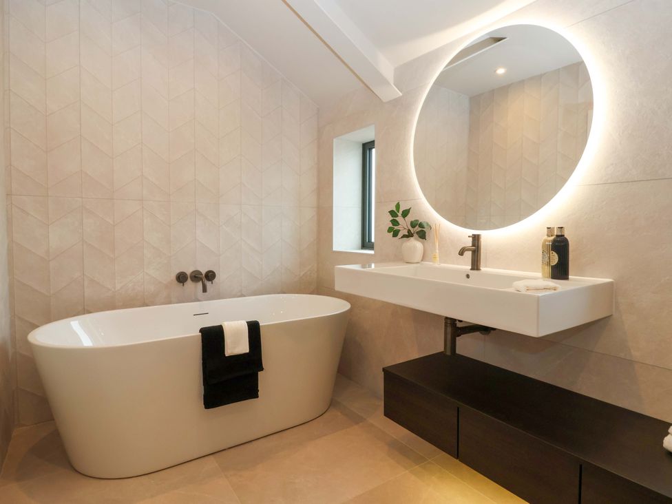 A bathroom with a bathtub and sink at Woldside in York