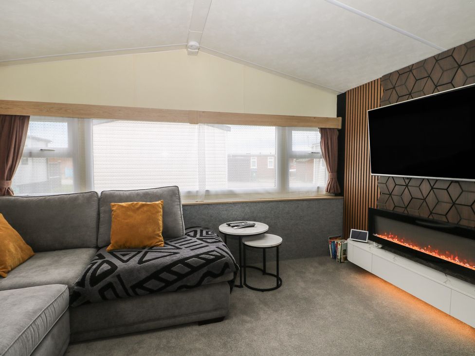 A living room with a sofa and television at 90 Solent Breezes Southampton