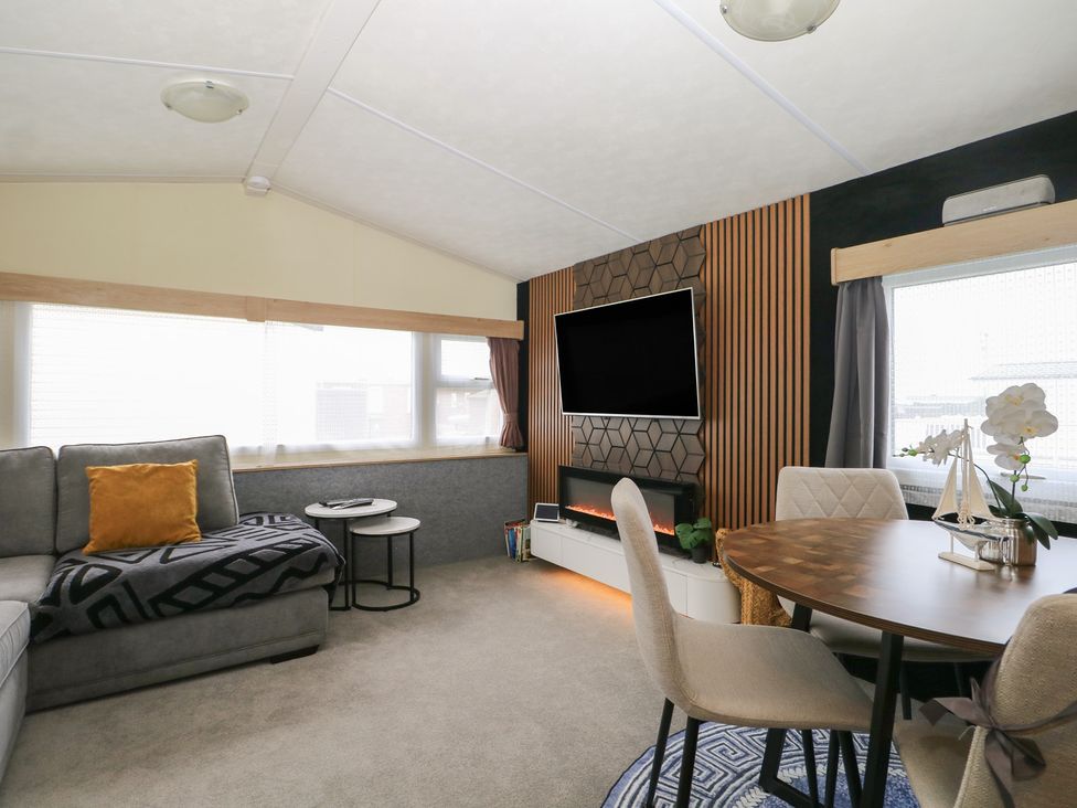 A living room with a sofa and TV at 90 Solent Breezes in Southampton