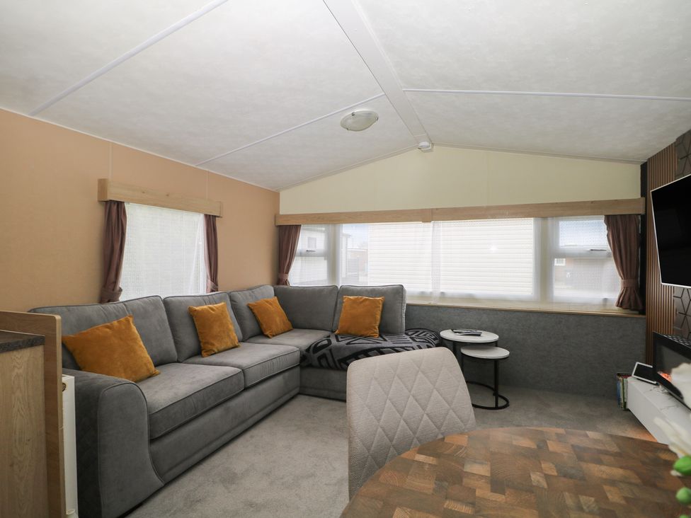 A living room with a sofa and table at 90 Solent Breezes Southampton