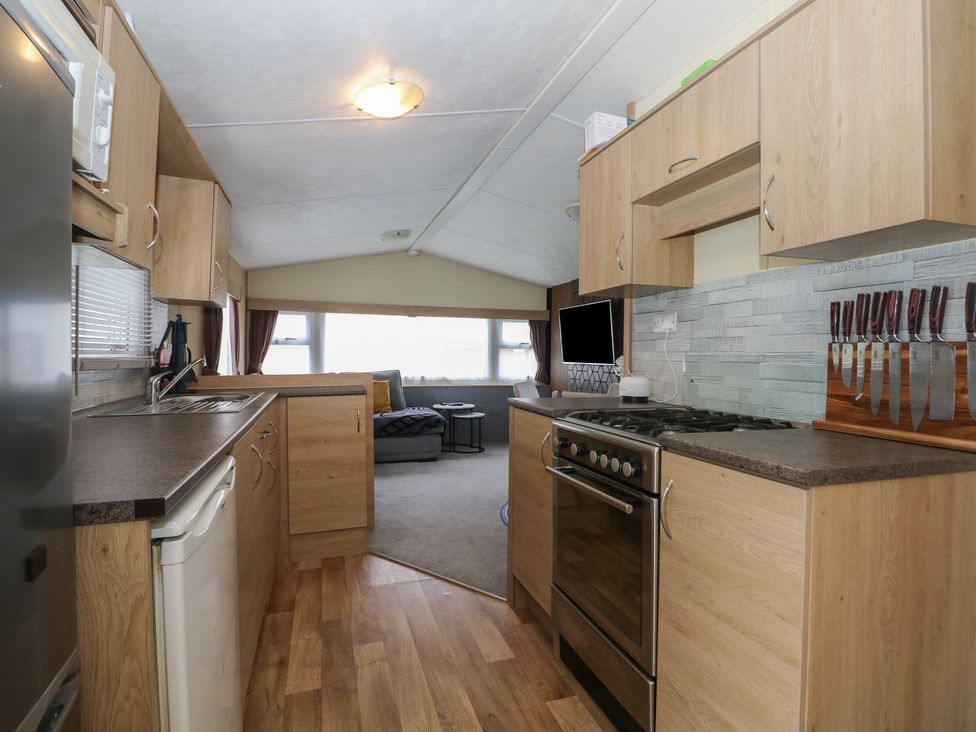 A kitchen with appliances and cabinetry at 90 Solent Breezes Southampton